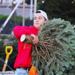 Griffin Golafshan prepares to send a tree home with a customer at the Purdy Tree Farms lot earlier this month at the Del Mar Fairgrounds. Photo by Leo Place