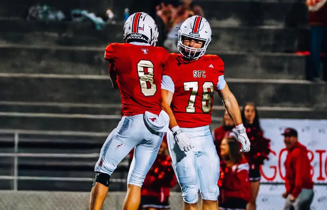 Santa Fe Christian junior wide receiver Chase Woolley (8) and junior lineman Dylan Tochterman (78) celebrate in the end zone on Friday against Steel Canyon. Photo by Isaac Angel