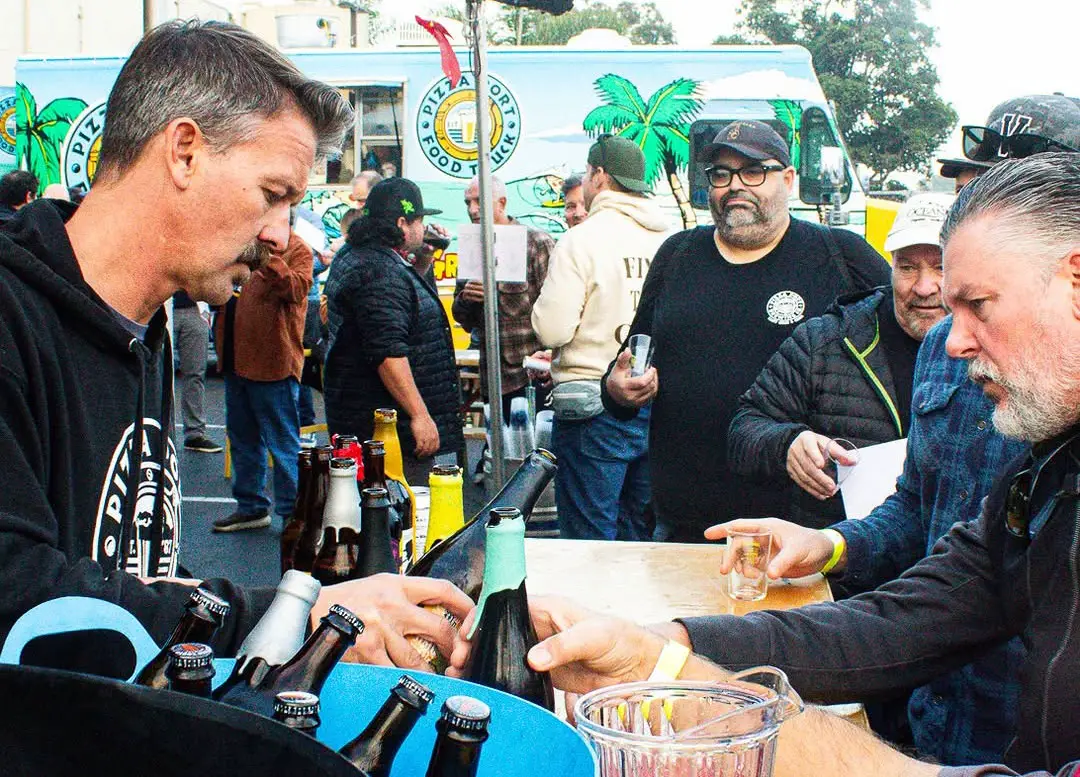 A server pours samples for guests during a previous Strong Ale Festival at Pizza Port Carlsbad, where high-ABV brews and a lively crowd have long defined the annual celebration. Courtesy photo/Pizza Port