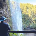 Visitors can walk behind South Falls, which makes a 177-foot drop into an amphitheater-like cave at Silver Falls State Park, a half-hour drive from Salem, Ore. Photo by E’Louise Ondash