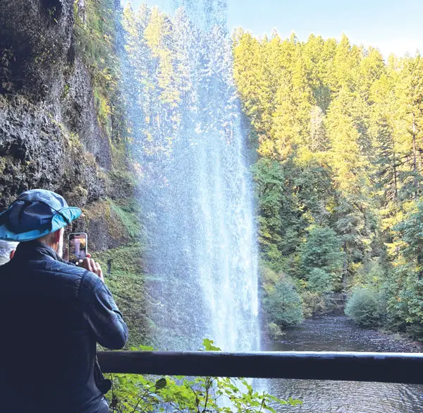 Visitors can walk behind South Falls, which makes a 177-foot drop into an amphitheater-like cave at Silver Falls State Park, a half-hour drive from Salem, Ore. Photo by E’Louise Ondash
