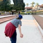 An athlete with developmental disabilities prepares to roll a bocce ball for the red team during a Sports for Exceptional Athletes practice. Photo by Jasmine Kirstein