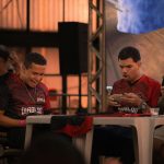 Two men playing video games at a table