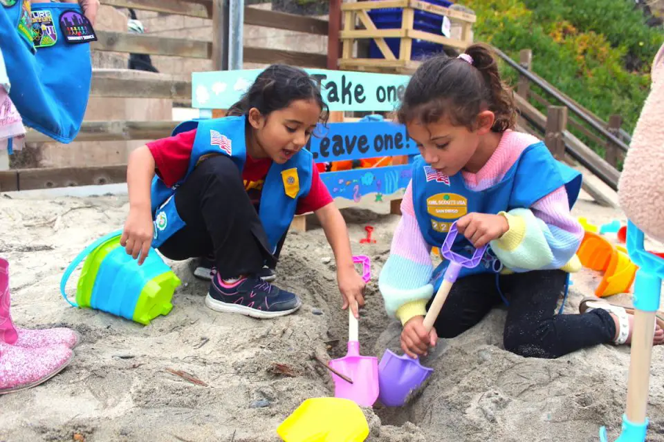 Girl Scouts Mika Mahzari, left, and Maya Garg, both age 5, play with toys from the Beach Toy Borrow Box at Fletcher Cove in Solana Beach on Thursday. Photo by Leo Place