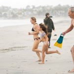 Participants dash into the Pacific during the inaugural First Day Polar Plunge on New Year's Day at South Cardiff State Beach. Photo by Tanya Perez