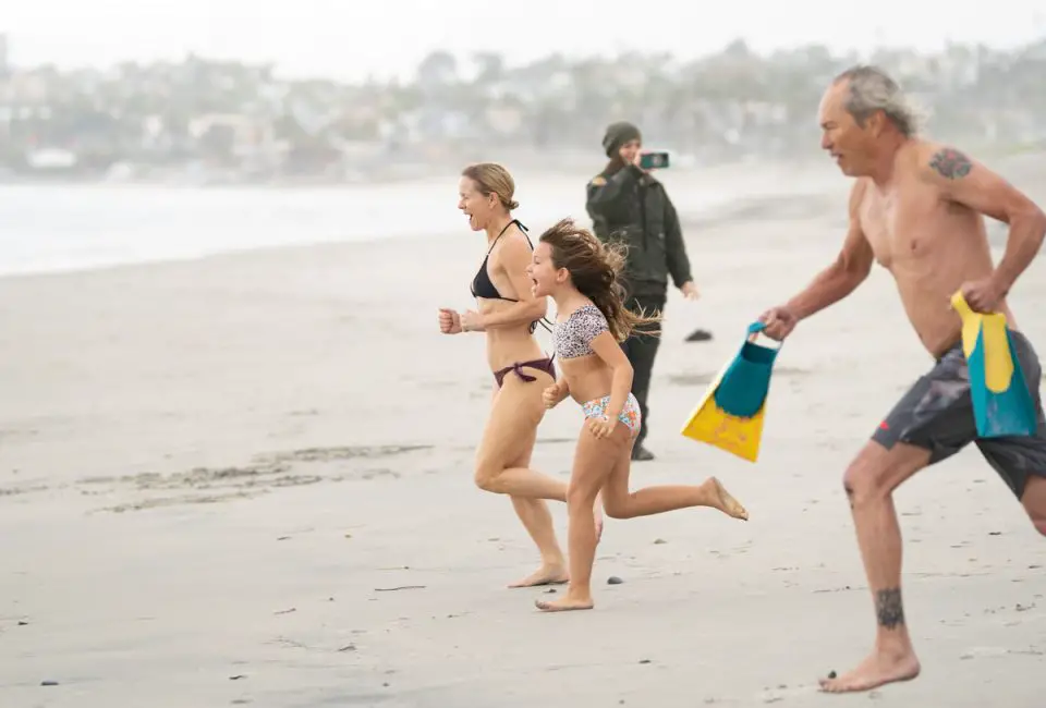 Participants dash into the Pacific during the inaugural First Day Polar Plunge on New Year's Day at South Cardiff State Beach. Photo by Tanya Perez