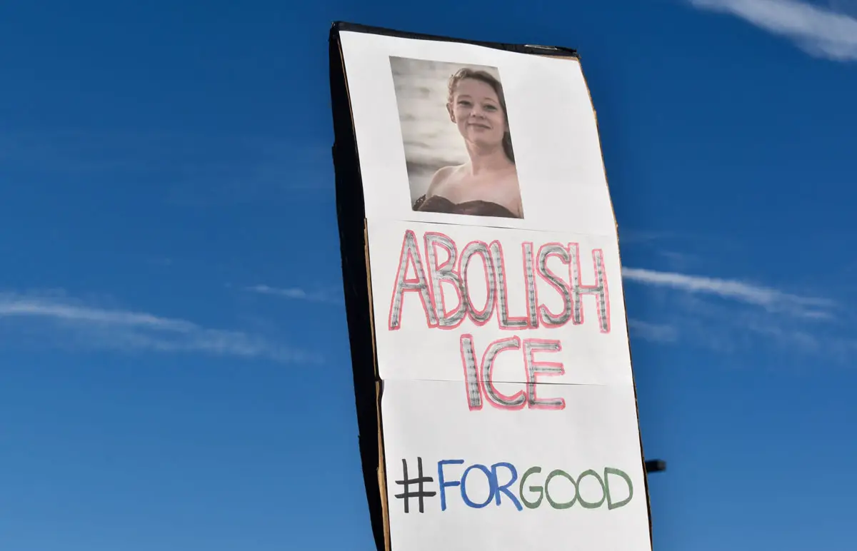 Signs at a Jan. 11 rally in Escondido pay tribute to Renee Good, a Minnesota mother and U.S. citizen who was killed by an ICE agent earlier this month. Photo by Samantha Nelson
