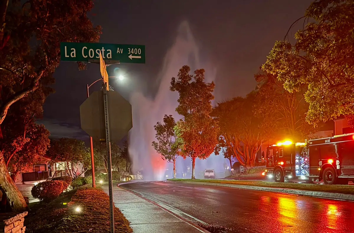 A ruptured water main sends a geyser of water high into the air following a valve failure in the La Costa area of Carlsbad early Monday morning.