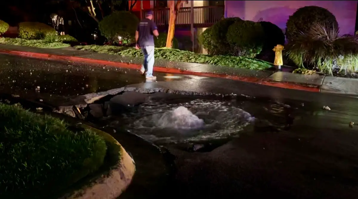 Flooding covers a section of roadway after a water main valve failure caused a break near Calle Timiteo and Caminito Malaga in Carlsbad early Monday.