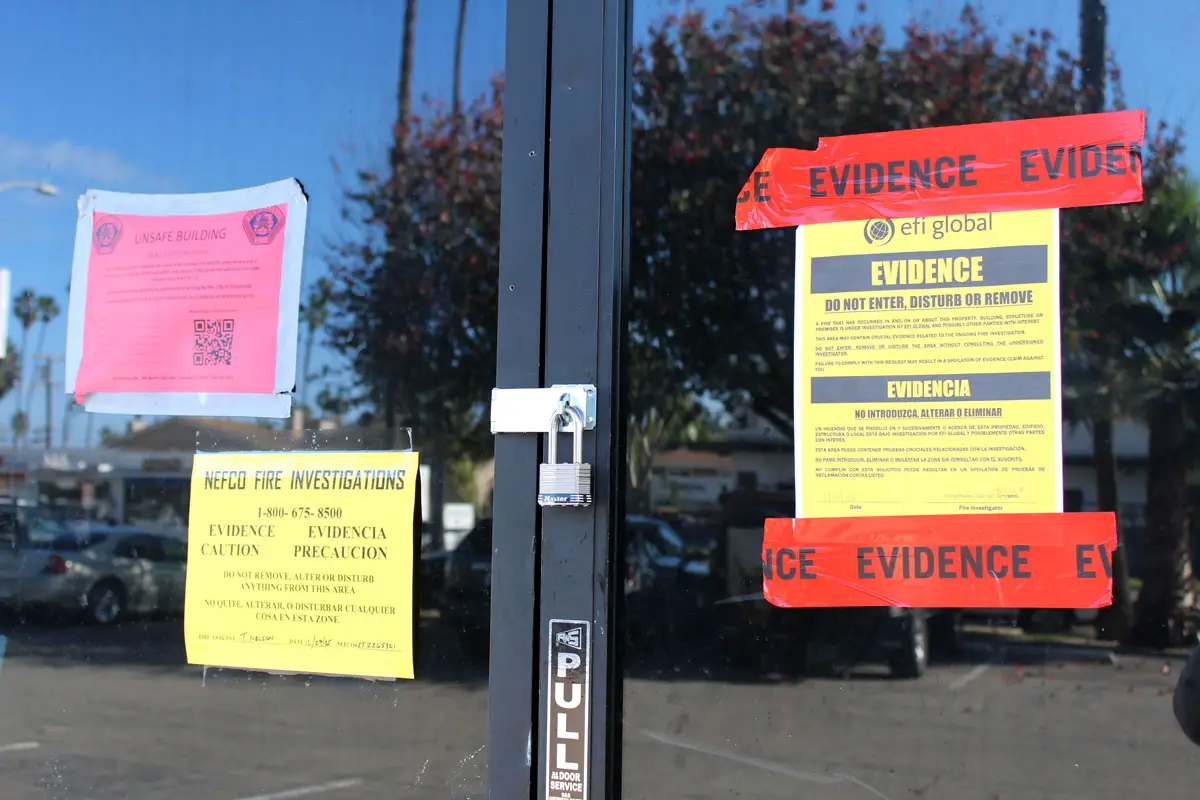 Warning signs are posted at the entrance of Bread and Cheese Eatery / And Breakfast Burritos in Oceanside following a Dec. 23 fire that caused significant damage to the building and forced the restaurant to close. Photo by Samantha Nelson
