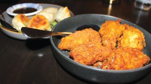 Pork potstickers with a soy-garlic dipping sauce and salt and pepper chicken wings. Photo by Rico Cassoni 