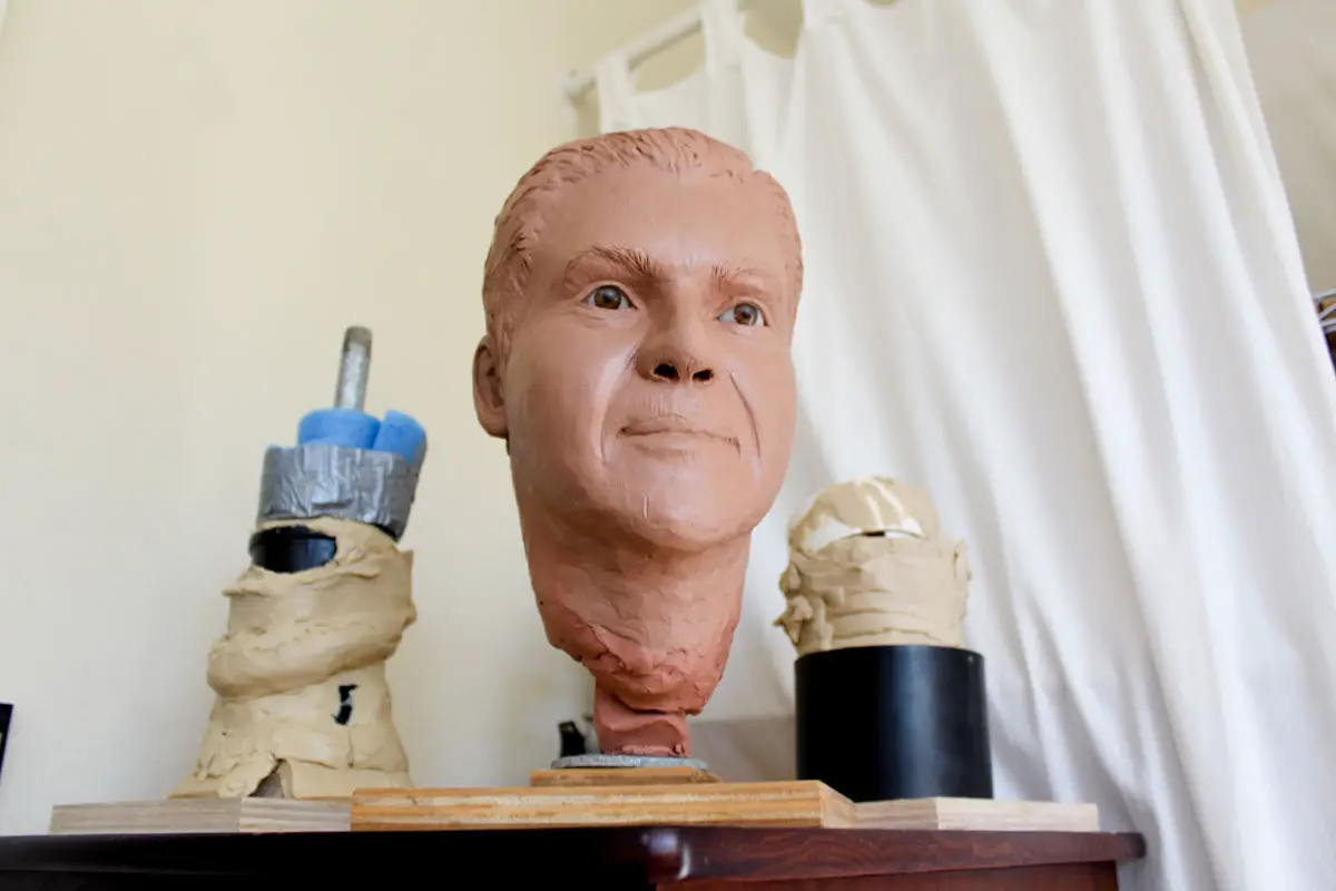 Clay busts, sketches and forensic reference books fill the Carlsbad home studio of forensic artist PJ Puterbaugh, where she creates facial reconstructions for unidentified victims nationwide. Photo by Jordan P. Ingram