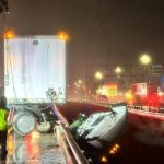 Firefighters rescue a truck driver after a big rig dangled from the San Luis Rey Bridge above the river early Wednesday in Oceanside. The driver was not hurt. Courtesy photo