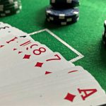 A deck of playing cards with poker chips