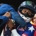 Elana Meyers Taylor holds her child in the finish area Monday after winning the gold medal in the women’s monobob at the Winter Olympics in Italy. Courtesy photo/Team USA