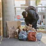 A woman gathers her bags on Feb. 24 at Encinitas Station. Photo by Jordan P. Ingram