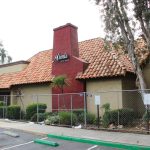 A chain-link fence surrounds the shuttered Mimi’s Bistro and Bakery, formerly Mimi's Cafe, on Vista Way in Oceanside. Photo by Cameron Adams