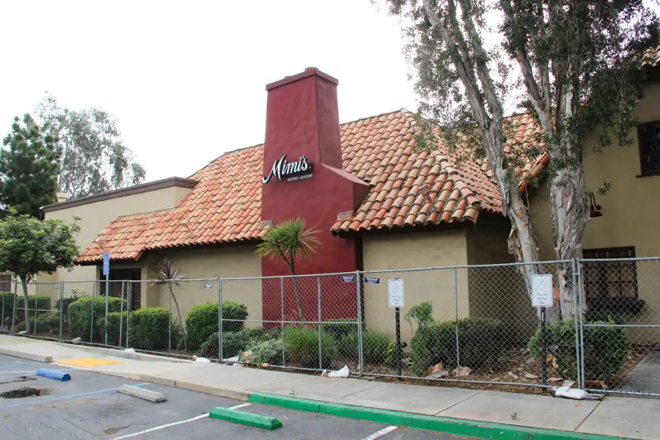 A chain-link fence surrounds the shuttered Mimi’s Bistro and Bakery, formerly Mimi's Cafe, on Vista Way in Oceanside. Photo by Cameron Adams