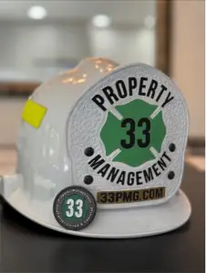 33 Property Management logo on firefighter helmet