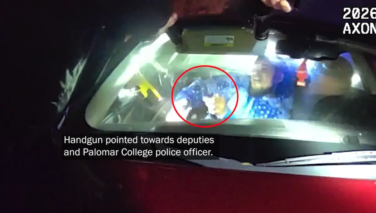 A screenshot from police body camera footage shows the moment when police say Andre Mendez raised a gun at officers, prompting them to discharge their weapons on Feb. 18. Officers used a taser (yellow object to the left) against Mendez just prior. Text on the screen added by the San Diego County Sheriff's Department.