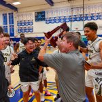 Army-Navy Academy head coach Terry Ryan holds the CIF San Diego Section Division III championship trophy after the Warriors defeated Ramona 53-37 on Feb. 27 at Mira Mesa High School. Photo by Kevin Mijares
