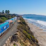 A train passes along Del Mar’s coastal bluffs, where erosion threatens the stability of the LOSSAN rail line. Photo by Oak City Drone