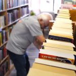 Joe McClusky, a longtime volunteer with Friends of the Oceanside Public Library, sorts books at the library bookstore at 323 N. Coast Highway on Friday. Photo by Leo Place