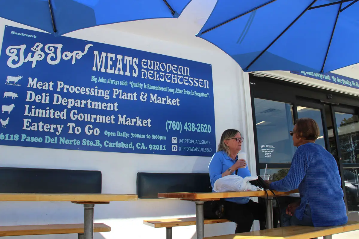 Customers dine on patio tables at the recently reopened Tip Top Meats in Carlsbad. Photo by Jordan P. Ingram