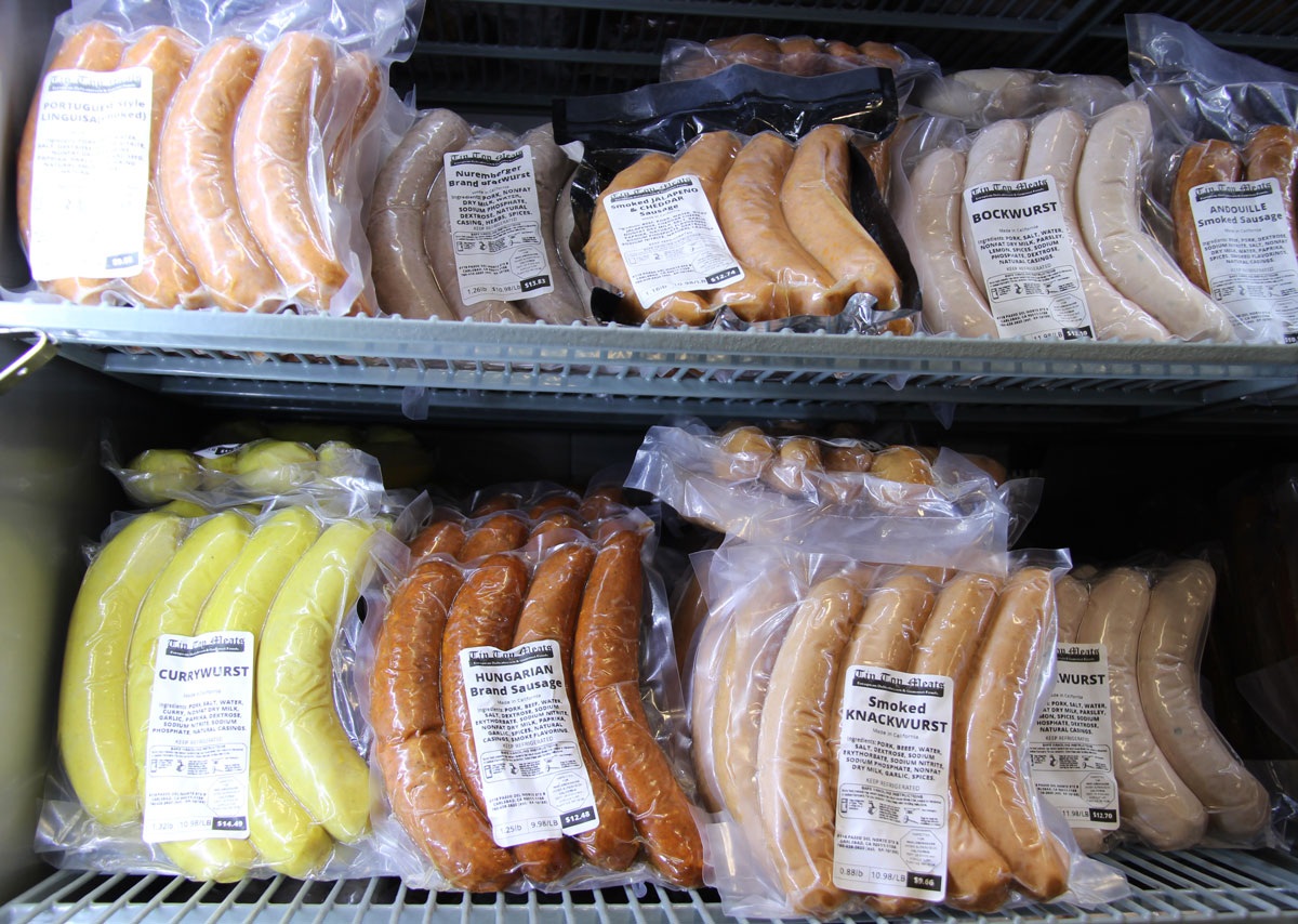 An assortment of house-made sausages fills the cooler at Tip Top Meats in Carlsbad, including currywurst, Hungarian brand sausage, smoked knockwurst, bockwurst, and andouille, all vacuum-sealed and ready for customers. Photo by Jordan P. Ingram