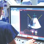 Dr. Hamed Aryafar, an interventional radiologist affiliated with Sharp Memorial Hospital, reviews an image during histotripsy, a noninvasive cancer treatment. Courtesy photo
