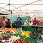 Customers gather at a produce stand during the Leucadia Farmers' Market, a weekly community event that has operated in Leucadia for the past 20 years. Courtesy photo