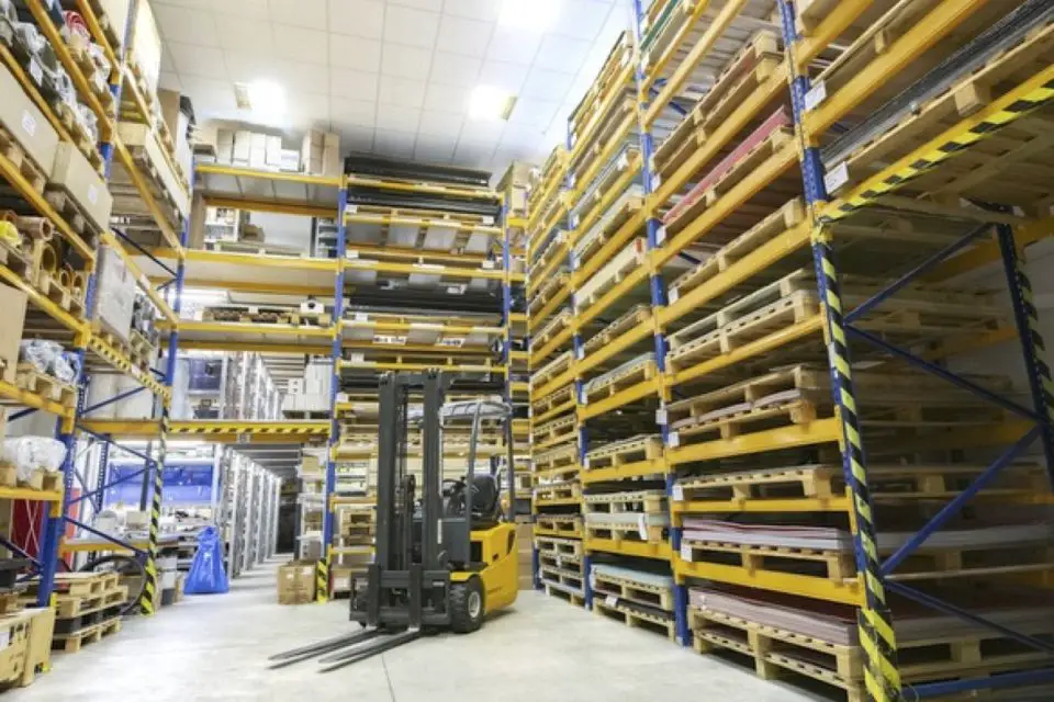 Automated warehouse with forklift and industrial shelving used for packaging and fulfillment operations