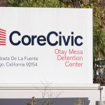 A sign outside the Otay Mesa Detention Center in San Diego County. A new California DOJ report found overcrowding and strained resources at immigration detention facilities across the state, including Otay Mesa. File photo