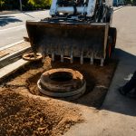 Construction workers at a sewer manhole.