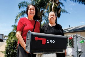 Gloria Santos, right, and her daughter Liz Santos are pictured outside of one of the two duplexes they own along East Barham Drive in San Marcos. The family is facing the possibility of eminent domain of their properties by the city, and is fighting a lawsuit over an easement by developer Urban Villages. Photo by Leo Place