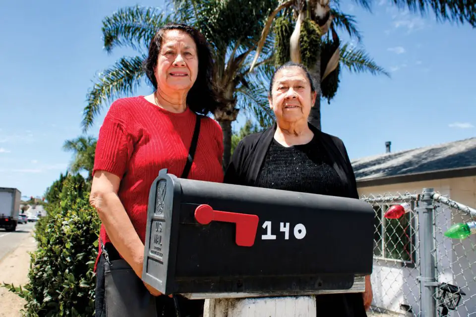 Gloria Santos, right, and her daughter Liz Santos are pictured outside of one of the two duplexes they own along East Barham Drive in San Marcos. The family is facing the possibility of eminent domain of their properties by the city, and is fighting a lawsuit over an easement by developer Urban Villages. Photo by Leo Place
