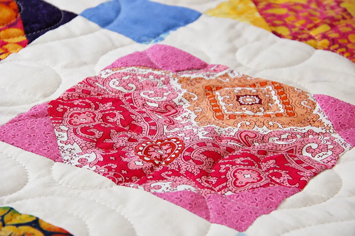 Handmade quilt squares created by local students showcase a variety of fabrics, colors and sewing techniques learned from master quilter Eleanor Burns. Photo by Samantha Nelson