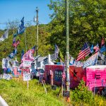 A yard in Virginia with Trump yard signs and American flags. Photo by Kristina Blokhin