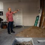 Adam Hardesty looks through the construction at his home in Carlsbad on Feb. 19, 2025. Hardesty wanted to convert the garage of his three-story condo into a ground-floor apartment despite opposition from his own Homeowners Association. Photo by Adriana Heldiz, CalMatters