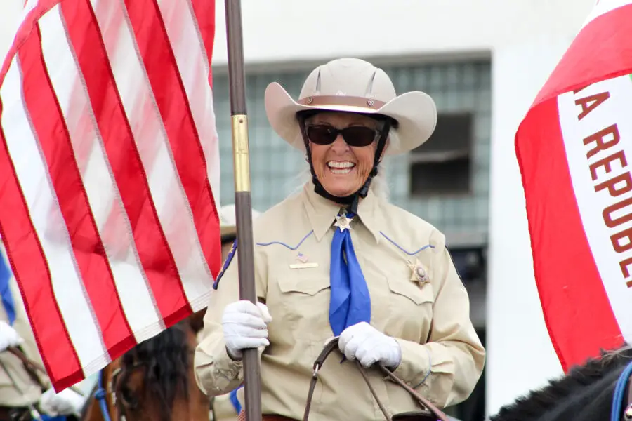 Members of the historic Escondido Mounted Posse, a nonprofit, equestrian parade group, travel on horseback along Coast Highway during the 2026 Oceanside Independence Day Parade. Photo by Samantha Nelson