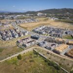 An aerial view of built homes and construction areas.