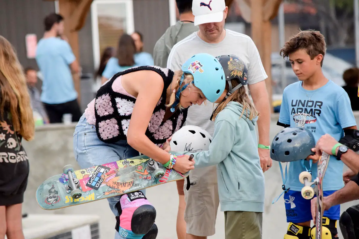 Olympic skateboarder Bryce Wettstein signs autographs and personal messages for young fans during Go Skate Day Family Night at the Magdalena Ecke Family YMCA Skate Park in Encinitas. Photo by Summer Hu