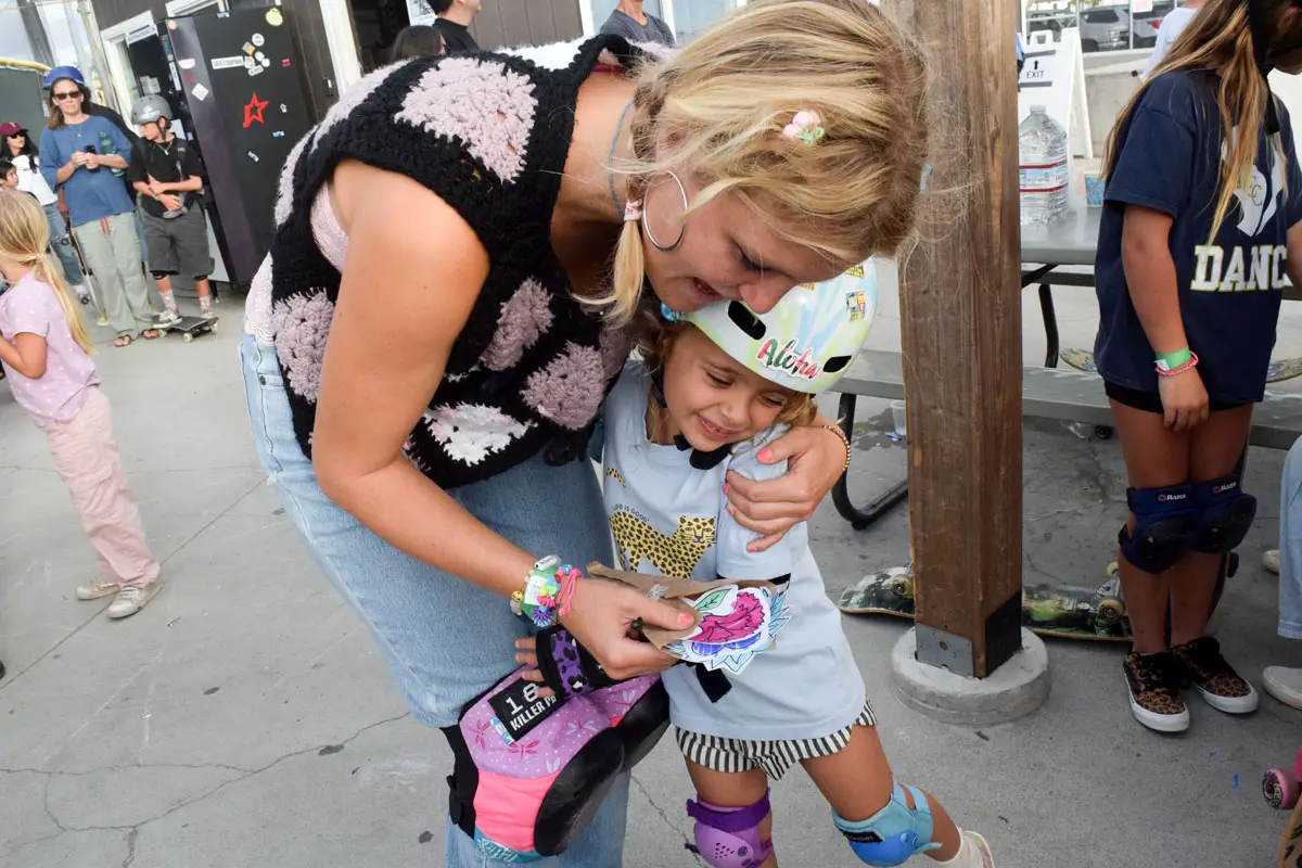 Bryce Wettstein signs helmets, skateboards and other items for young fans at the YMCA skate park in Encinitas. Photo by Summer Hu
