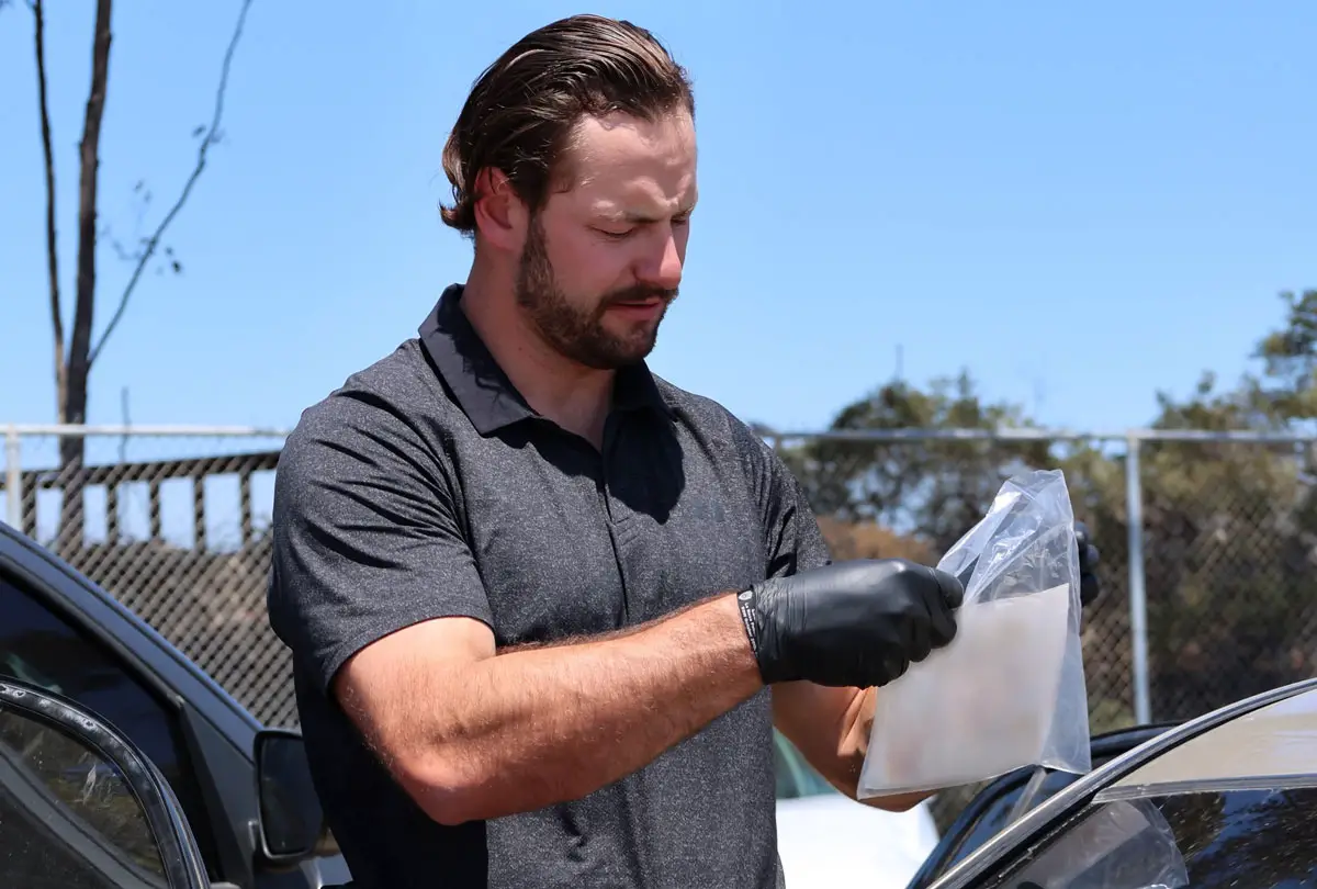 A Carlsbad detective bags evidence related to a series of Jeep thefts. Courtesy photo/CPD