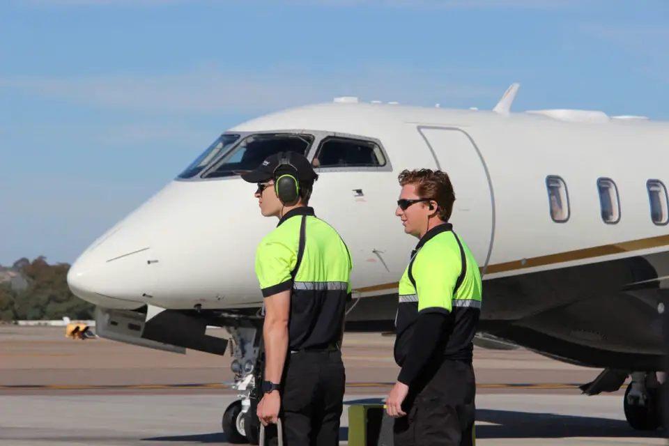 Ground crew members prepare for an arriving flight on the tarmac at McClellan-Palomar Airport in Carlsbad. File photo/Jordan P. Ingram