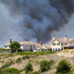 A brush fire burns near a Carlsbad neighborhood in 2014. Photo by Malisa Nicolau