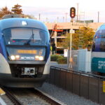 Two Sprinter trains pass each other at a station.