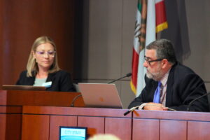 Two people pictured on a dais.