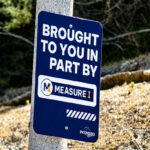 A sign highlighting work completed along a sidewalk on Seven Oakes Road in Escondido because of Measure I, the city's one-cent sales tax initiative approved by voters in 2024. Photo by Samantha Nelson
