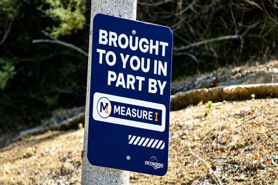 A sign highlighting work completed along a sidewalk on Seven Oakes Road in Escondido because of Measure I, the city's one-cent sales tax initiative approved by voters in 2024. Photo by Samantha Nelson